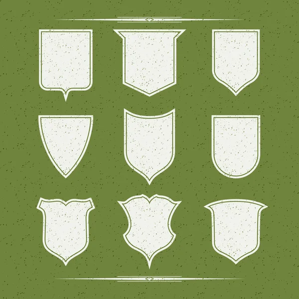 Set of nine  different forms of shields. White on a green backgr — Stock Vector