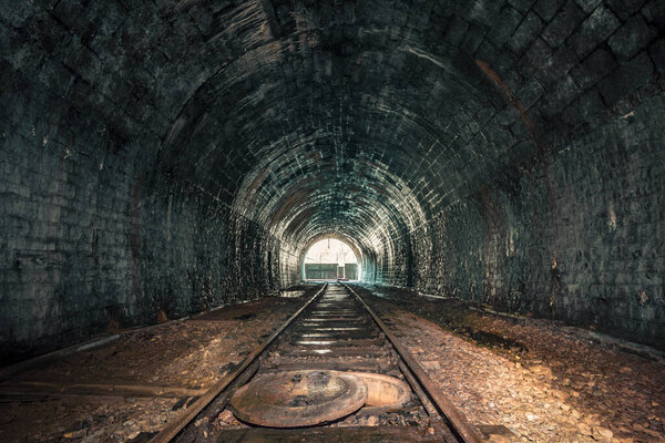 Creepy old abandoned railway tunnel, decayed for decades, a lost place with natural stalactites