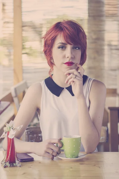 Hipster teenage girl in a coffee shop, retro tones — Stock Photo, Image