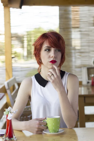 Hipster teenage girl in a coffee shop — Stock Photo, Image