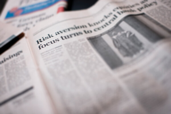 Focus on written risk on a newspaper