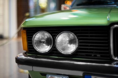 İzmir, Türkiye - 21 Haziran 2021: 1975 ile 1983 yılları arasında Almanya 'da üretilen bir BMW 320 marka yeşil araba farının yakın çekimi. İzmir 'de Editör Fotoğrafı.