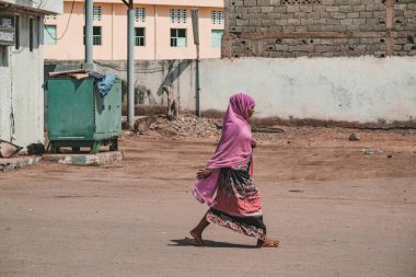 Djibouti, Djibouti - May 21, 2021: A Djiboutian woman walking in local dress in Djibouti. Editorial shot in Djibouti