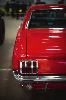 İzmir, Türkiye - 4 Aralık 2021: Fuar İzmir 'de bir otomobil fuarında kırmızı renkli klasik bir Ford Mustang arabasının arka görünümü.
