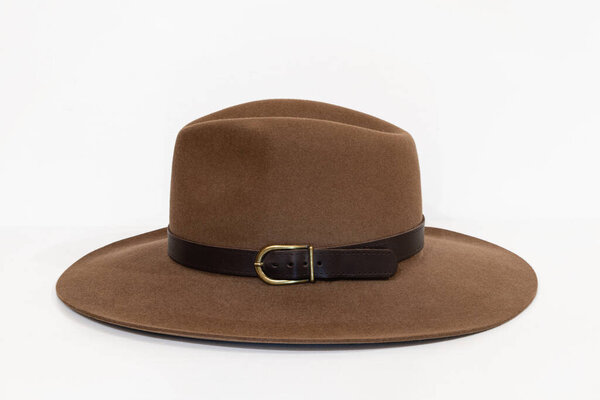 Classic cowboy brown felt hat with strap and copper closure on white background
