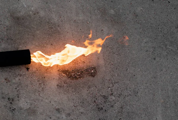 Long flame of a gas burner on dark gray background — Stock Photo, Image