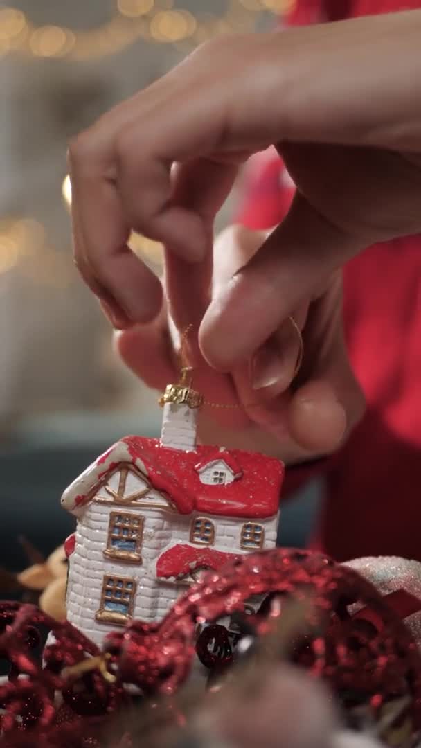 Kerstboom versieren. Verticale weergave van vrouwelijke handen nemen kerstspeelgoed uit doos met speelgoed. Close-up en slow motion — Stockvideo