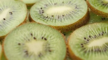 Kiwi fruit. Camera slowly pans down to show macro shot of fresh juicy sliced kiwi fruit