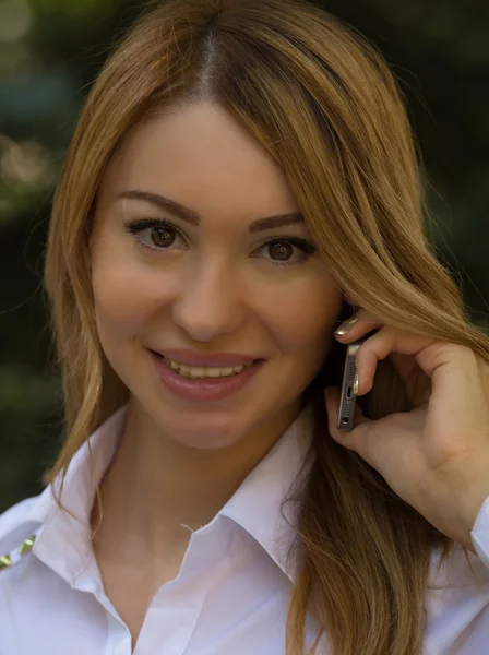 Smiling woman talking on a mobile phone Stock Image