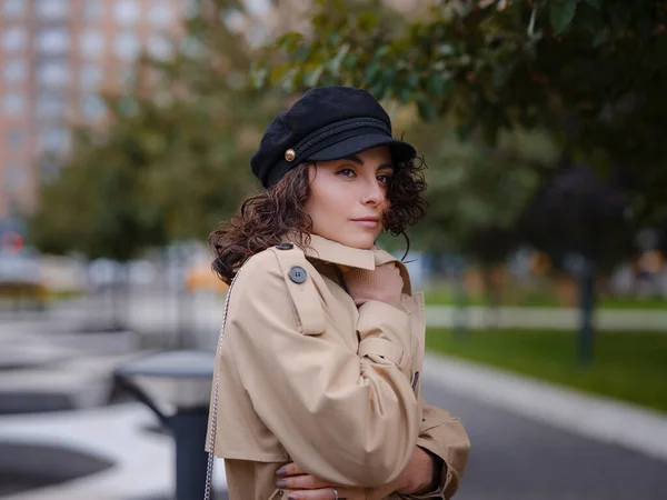 Young beautiful woman in autumn street. Young hispanic or Armenian woman wearing elegant style standing at the Moscow city.