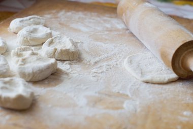 Dough for dumplings on the kitchen blackboard clipart