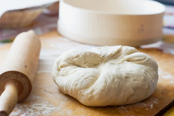 Ball of raw dough on a cutting board in the — Stock Photo, Image