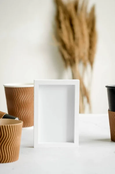 Empty White Frame Many Different Craft Paper Disposable Cups Set — Stock Fotó