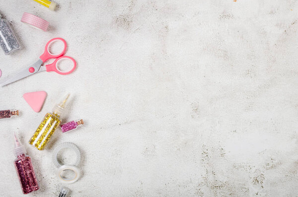 Girly set set for creativity in pink pastel stationery shades glitter bottles, decorative tape, scissors on grey background, flatlay,  mockup