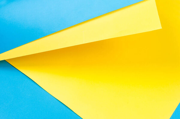 Color papers geometry flat composition background with yellow and blue tones. Colors symbols of Ukraine.