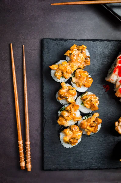 Tasty Rolls Set Stone Plate Sauces Chopsticks Ginger Wasabi Dark — стоковое фото