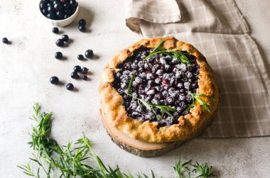 Homemade blackcurrant galette on old concrete background. Open pie. Top view of homemade pie crust on the table. rustic home baked fruit pie.