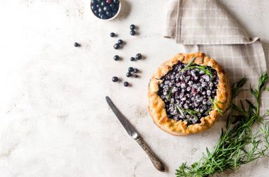 Homemade blackcurrant galette on old concrete background. Open pie. Top view of homemade pie crust on the table. rustic home baked fruit pie.