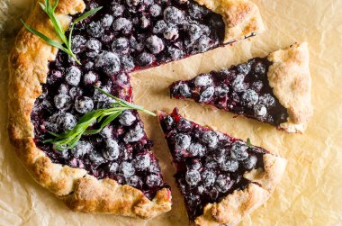 Homemade blackcurrant galette on old concrete background. Open pie. Top view of homemade pie crust on the table. rustic home baked fruit pie.