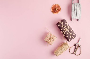 Christmas wrapped presents in kraft paper with different organic decoration. Eco friendly packaging. Christmas zero waste, ecological concept of eco-friendly. vintage retro style, Handmade christmas decorated 