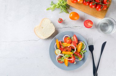 Healthy salad with red and yellow cherry tomato, sesame and parsley in plate. Summer food concept. Selective focus