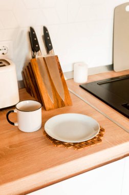 Home interior with kitchen, with dishes. Modern interior. Domestic things. Fresh peach and mug tea for breakfast on the wooden table
