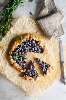 Homemade blackcurrant galette on old concrete background. Open pie. Top view of homemade pie crust on the table. rustic home baked fruit pie.