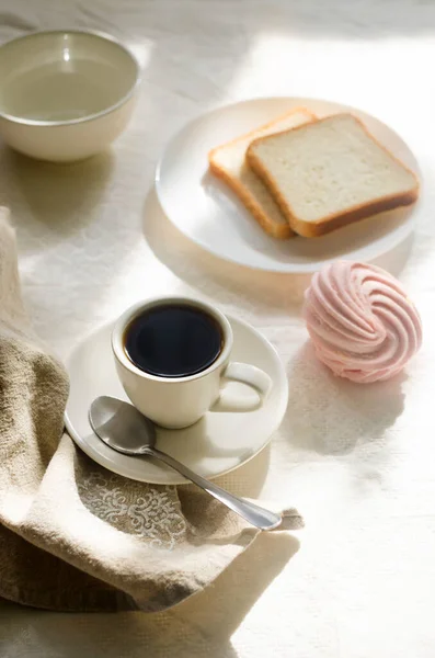 Breakfast with coffee, sweets and toast. Cozy calm meal in the morning in the sunshine