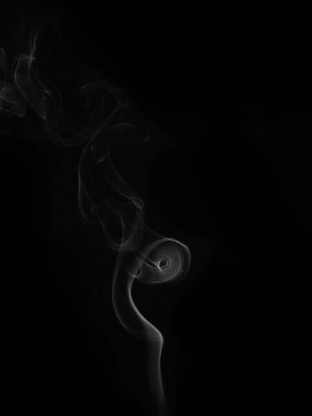 Wax candle with burning wick and smoke, isolated on a black background
