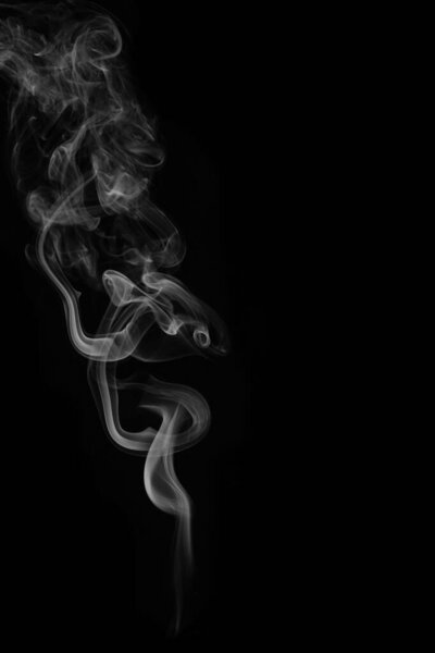 Wax candle with burning wick and smoke, isolated on a black background