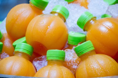 Plastik şişelerdeki portakal suyu portakal gibi görünüyor.