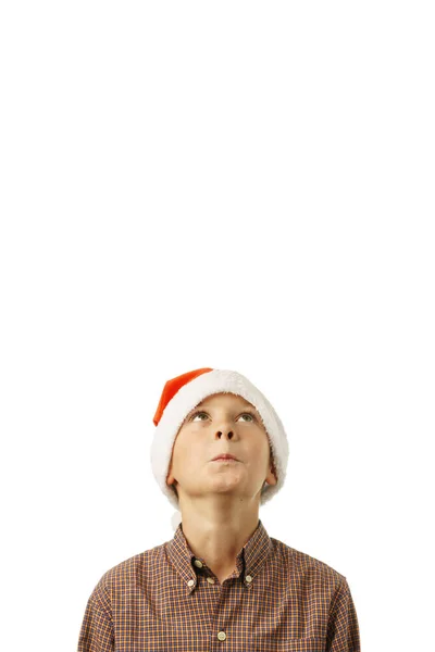 Isoliert Auf Weißem Hintergrund Schaut Ein Junge Mit Weihnachtsmannmütze Erstaunt — Stockfoto