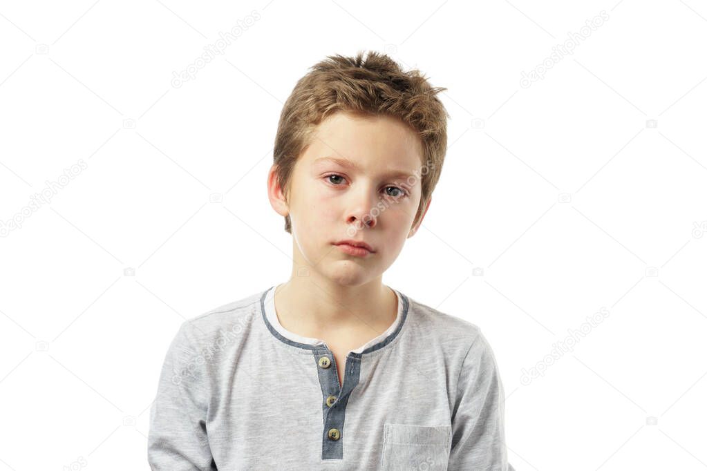 portrait of a sad boy isolated on white background. cute caucasian child sadly looking at the camera