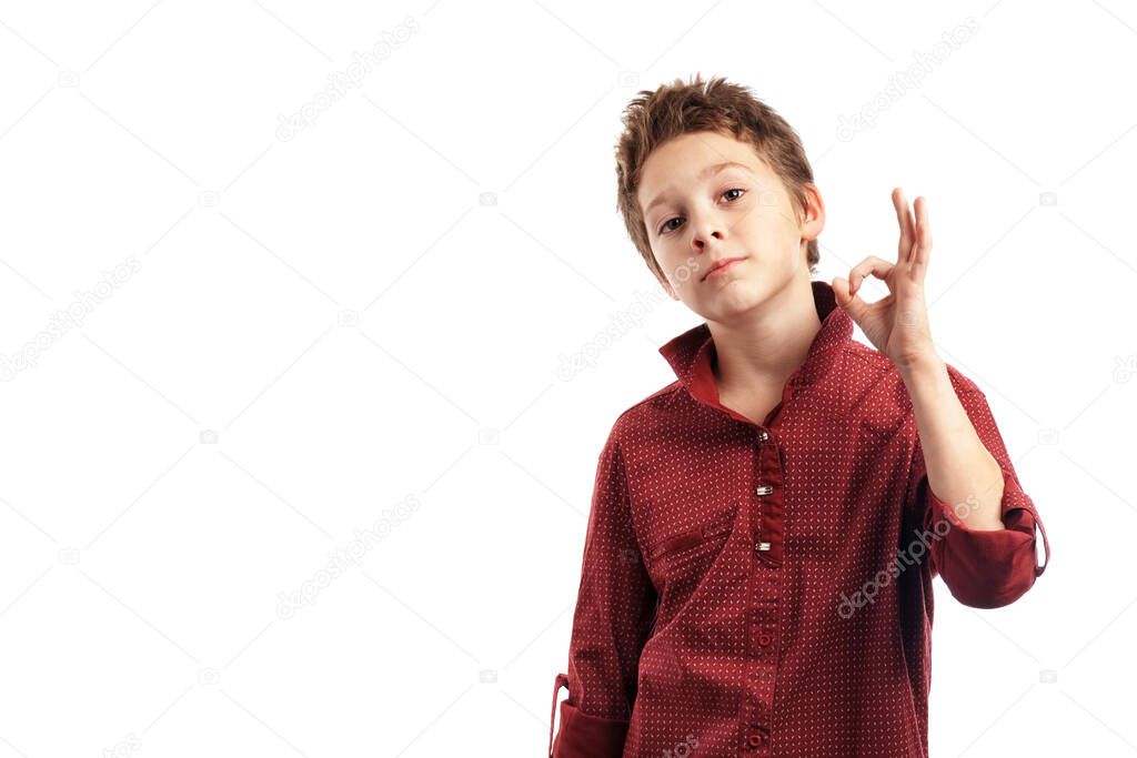 boy in a red shirt shows ok fingers, is isolated on a white background.