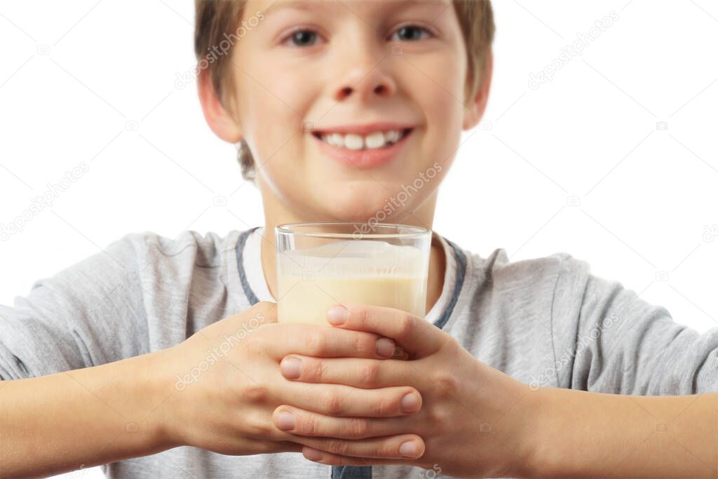 portrait of a happy caucasian boy with a glass of milk, isolated on white background. advertising concept.