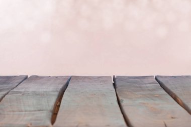 wood table top on pastel abstract blurred background and white bokeh.