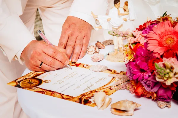 Newlyweds signing marriage license or wedding contract