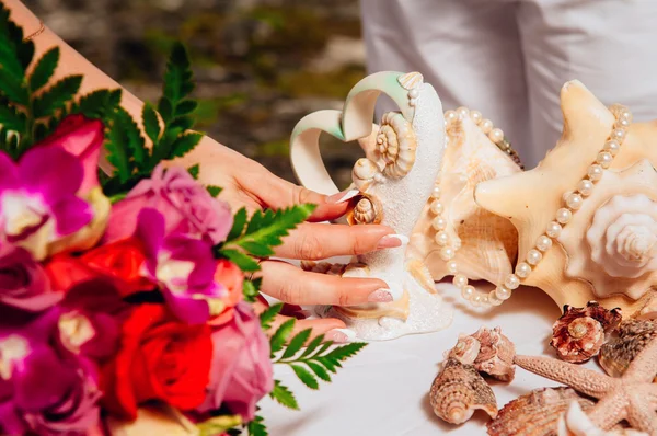 Wedding rings on sea shells