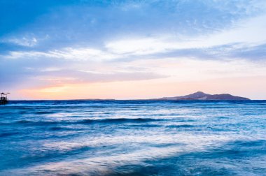 Gün batımında adanın manzarası. Güzel sihirli gün batımı denizin üzerinde