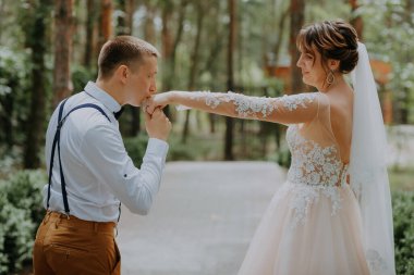 Genç bir çiftin şehvetli portresi. Düğün fotoğrafı dışarıda. Gelin ve damadın parkta düğün fotoğrafı. Yeni evli çift kucaklaştı..