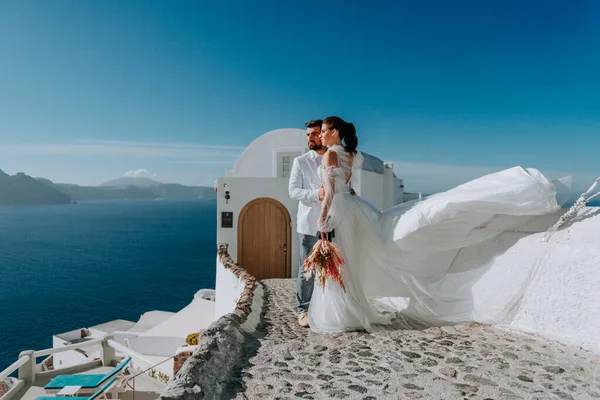 Bela noiva e noivo em seu dia de casamento de verão na ilha grega Santorini — Fotografia de Stock