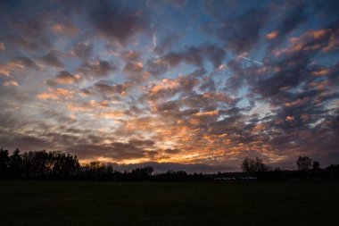 cloudy colorful sunset above forest