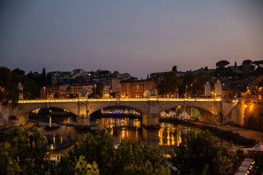 rome bridge over tiber at dusk