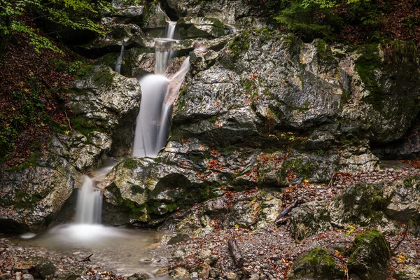 waterfall over rocks in the forest