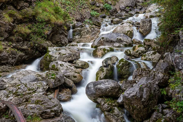 kuhflucht waterfall in forest long exposure alps germany