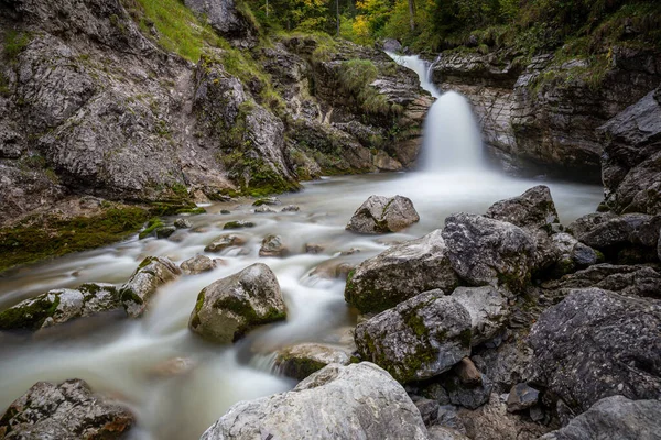 kuhflucht waterfall in forest long exposure alps germany