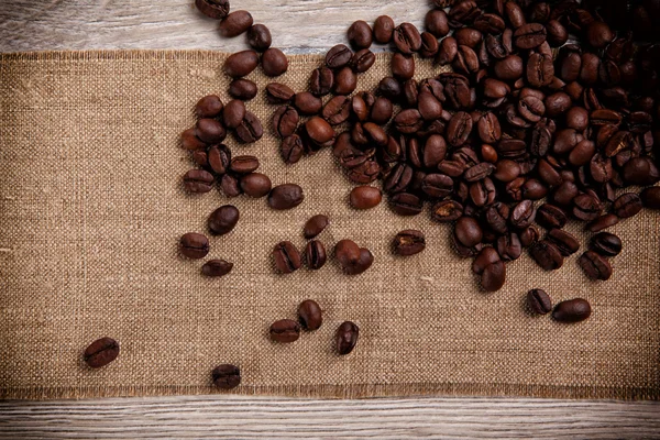 Coffee beans on a burlap background — Stock Photo, Image