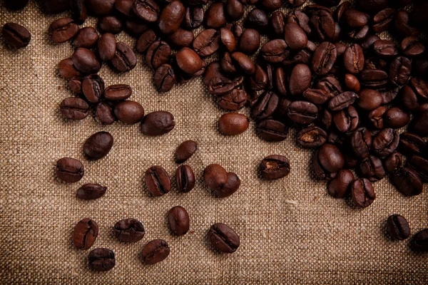 Coffee beans on a burlap background — Stock Photo, Image