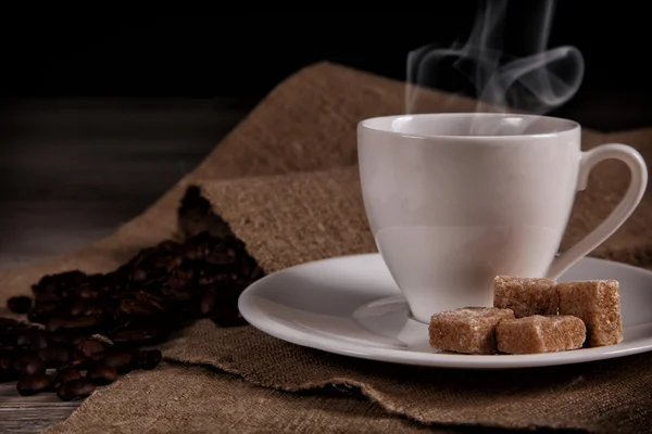 Warm espresso cup and saucer with brown cane sugar — Stock Photo, Image