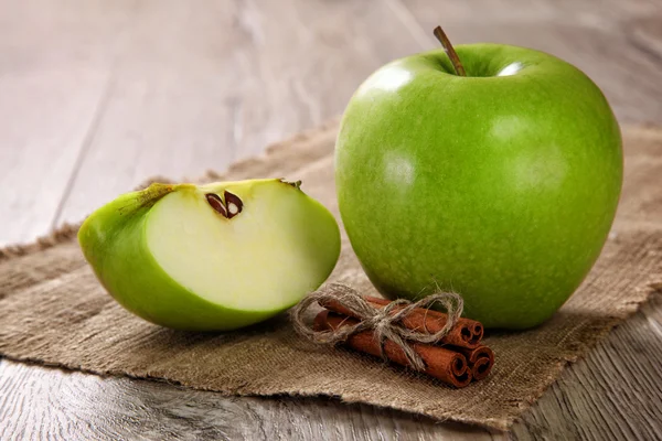 Green Apples with Cinnamon Sticks on a Burlap — Stock Photo, Image